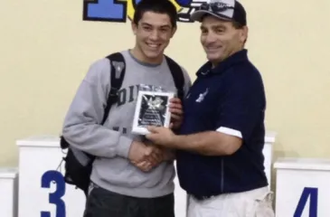 Michael Wright the 2nd and Dave Watts. Dave Watts handing Michael Wright the 2nd most outstanding wrestler at the Redwood Wrestling Invitational.
